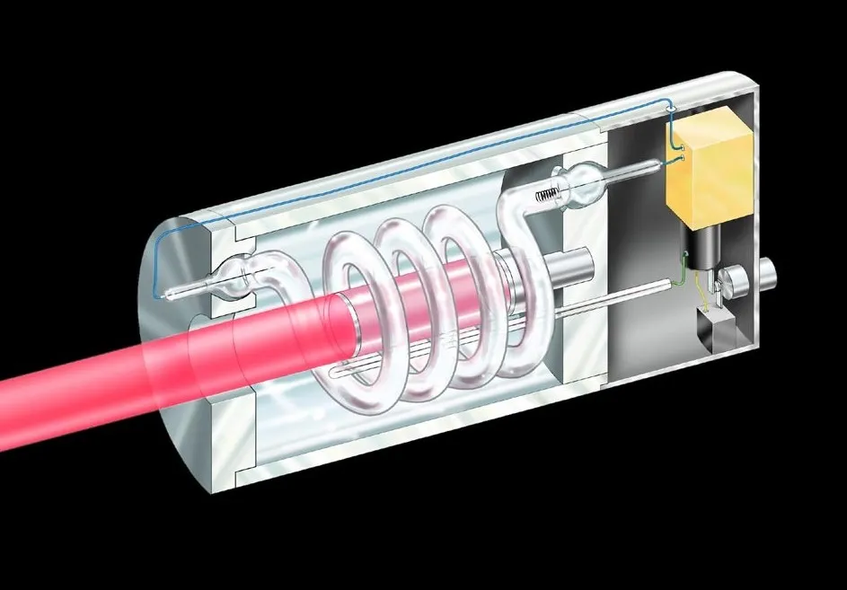 Diagram of a ruby laser: the ruby rod sits inside a coiled flash lamp, with mirrors at both ends. The red beam emerges from the partially reflective mirror on the left.